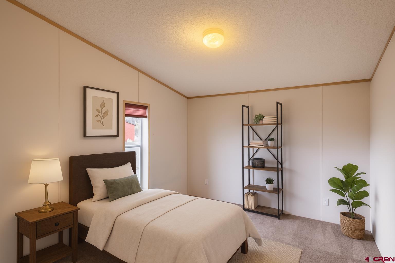 901 6530 Road, Unit 1203 Montrose, CO 81401 - Photo 11 of 22 a bedroom with a bed and a potted plant