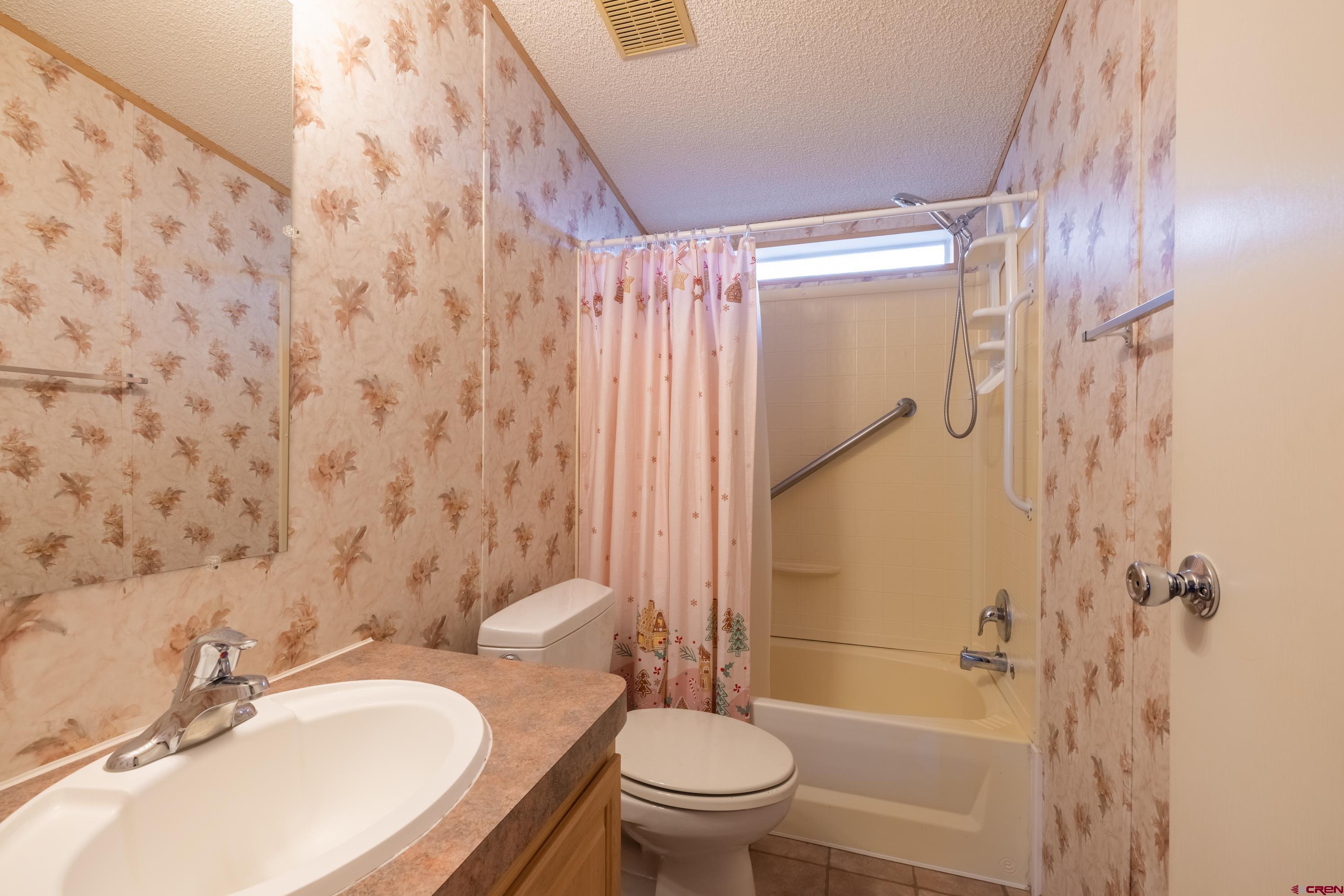 901 6530 Road, Unit 1203 Montrose, CO 81401 - Photo 13 of 22 a bathroom with a sink toilet and shower
