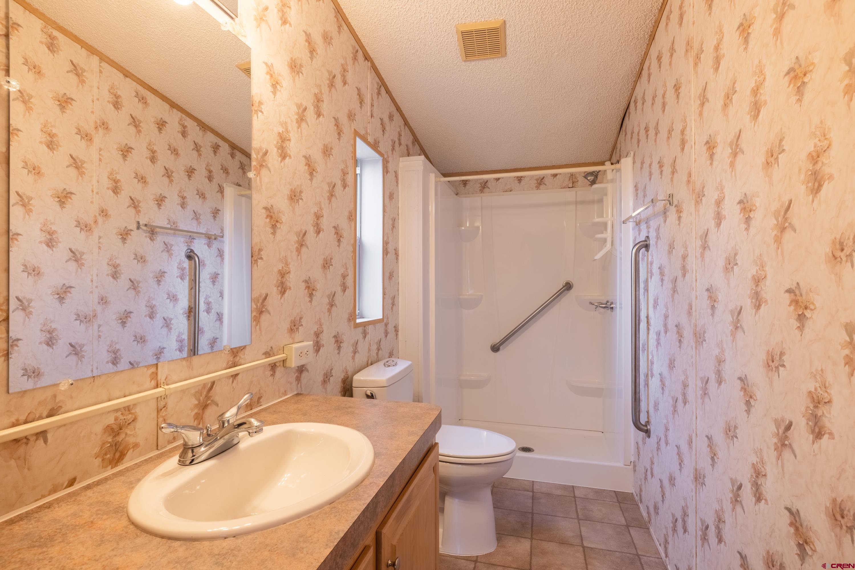 901 6530 Road, Unit 1203 Montrose, CO 81401 - Photo 17 of 22 a bathroom with a sink toilet and shower