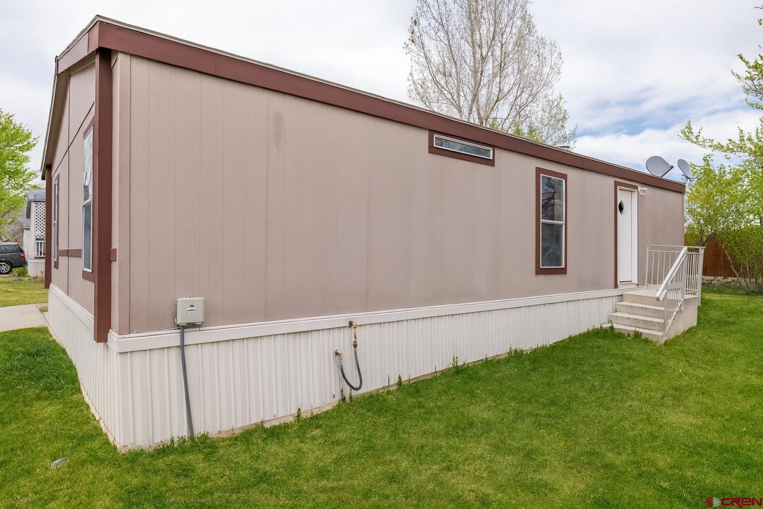 901 6530 Road, Unit 1203 Montrose, CO 81401 - Photo 22 of 22 a view of a backyard with cabin