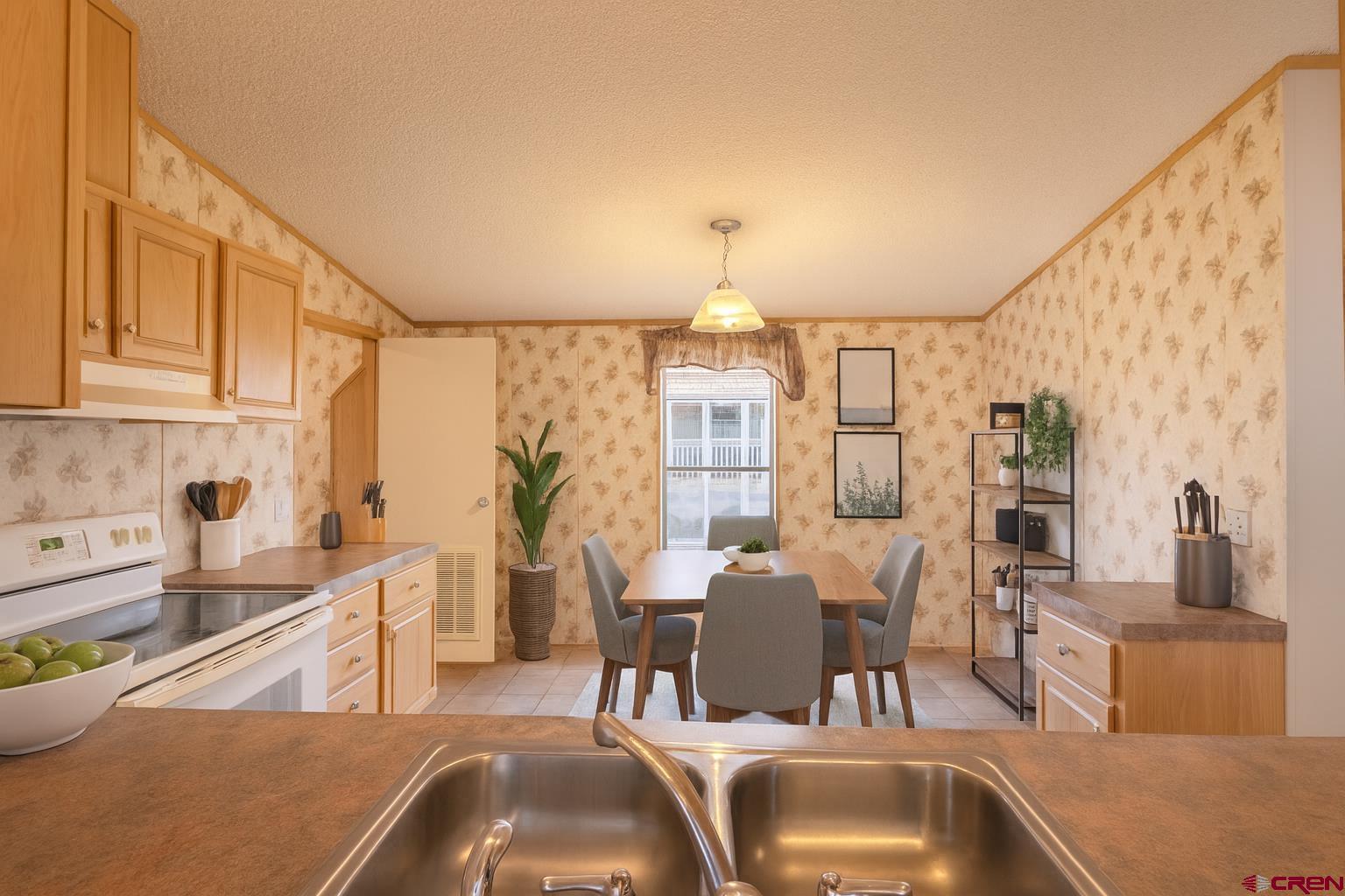 901 6530 Road, Unit 1203 Montrose, CO 81401 - Photo 5 of 22 a kitchen with stainless steel appliances kitchen island granite countertop a sink and cabinets