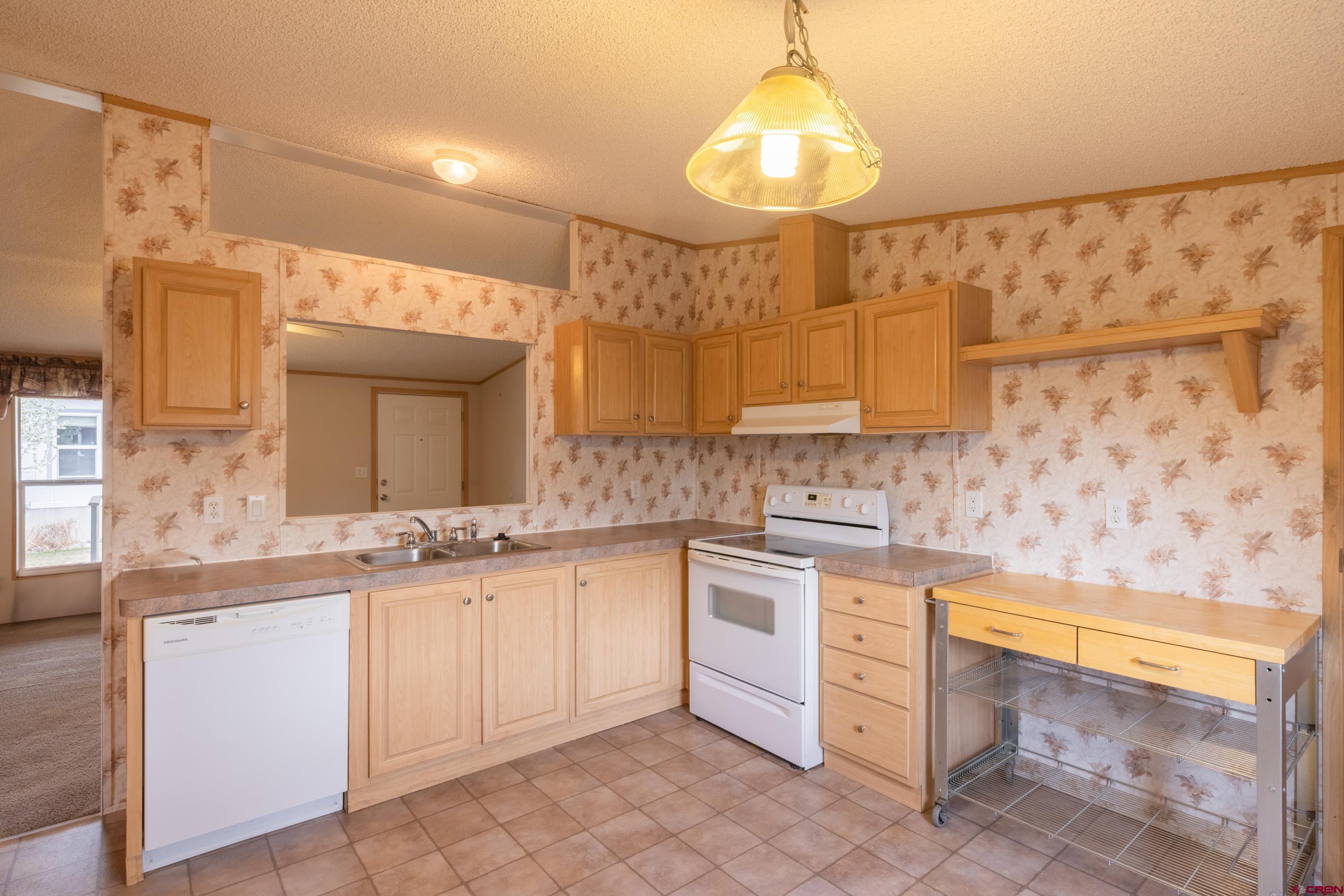 901 6530 Road, Unit 1203 Montrose, CO 81401 - Photo 7 of 22 a kitchen with a sink cabinets and window