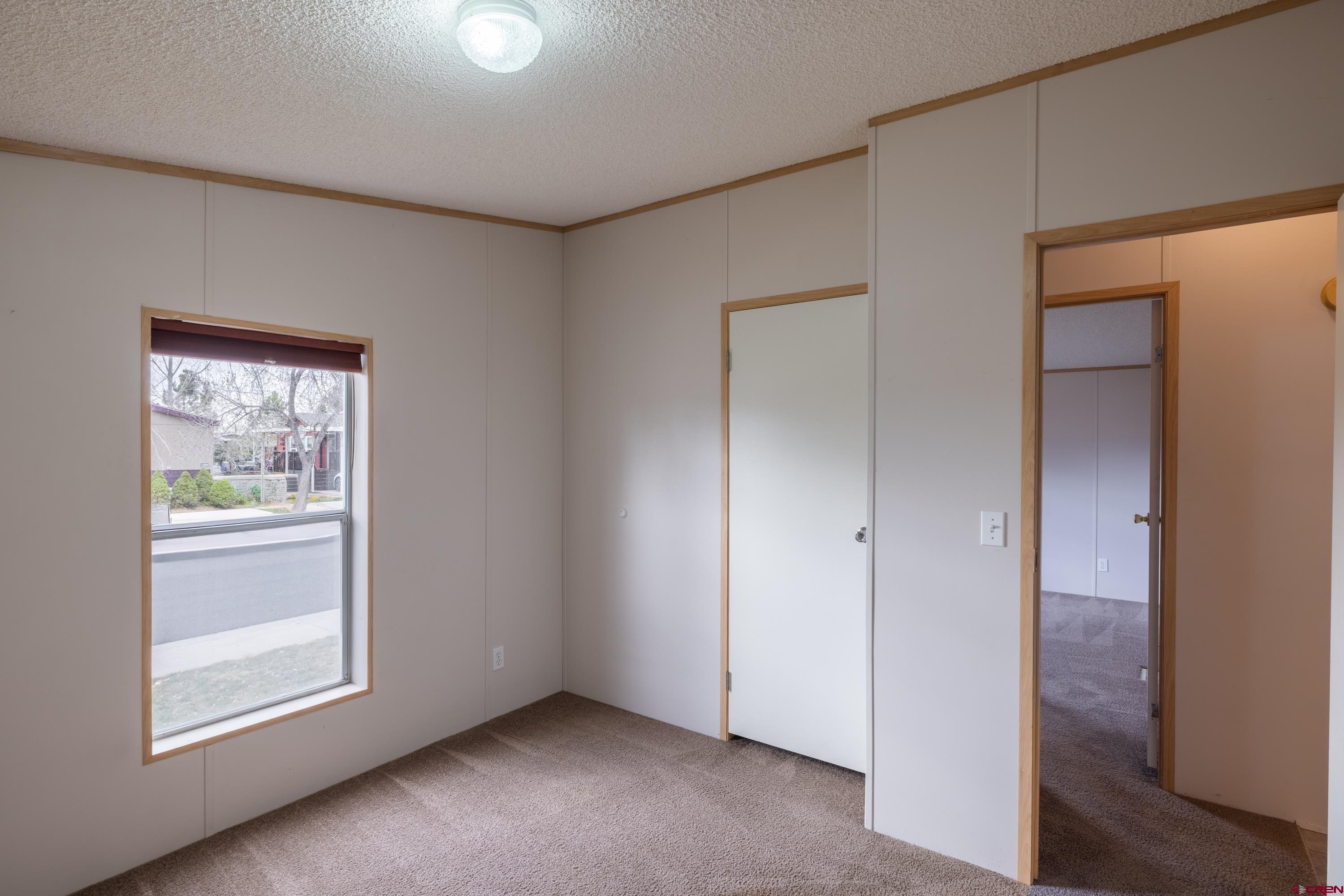 901 6530 Road, Unit 1203 Montrose, CO 81401 - Photo 10 of 22 an empty room with windows and closet