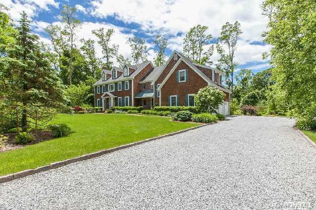 6 Flax Pond Woods Road Old Field, NY 11733 - Photo 1 of 1 a front view of a house with a yard and garage