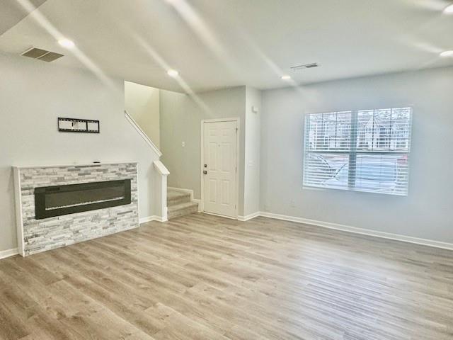 4433 Watson Ridge Drive Stone Mountain, GA 30083 - Photo 11 of 48 an empty room with wooden floor fireplace and windows