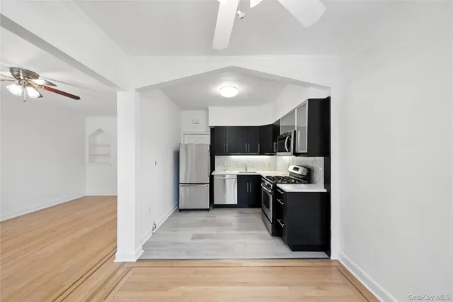 a kitchen with stainless steel appliances a refrigerator sink and stove