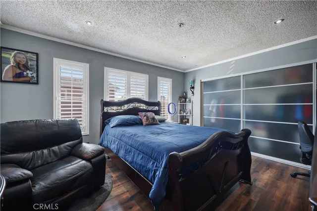 a bedroom with a bed and a couch