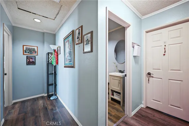 a view of a hallway with wooden floor and closet