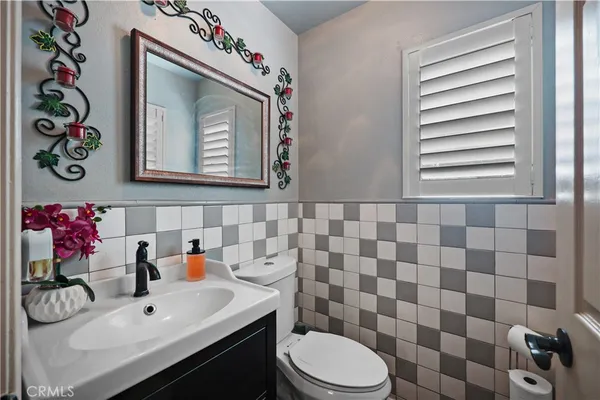 a bathroom with a sink mirror and toilet