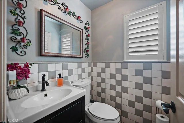 a bathroom with a sink mirror and toilet