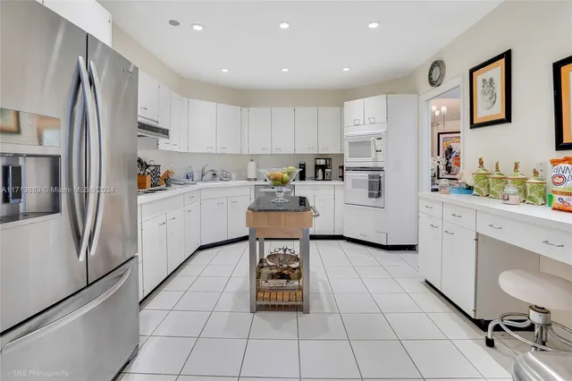 a kitchen with stainless steel appliances a refrigerator sink and cabinets