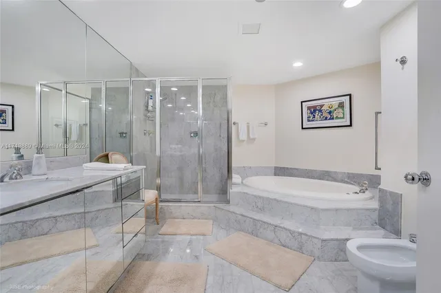 a bathroom with a double vanity sink toilet and shower