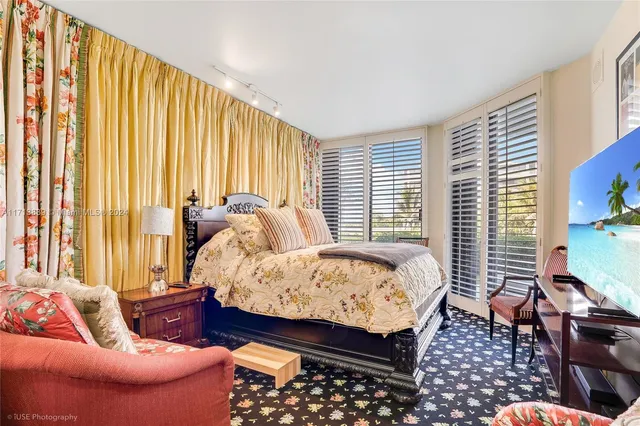 a bedroom with furniture and a large window