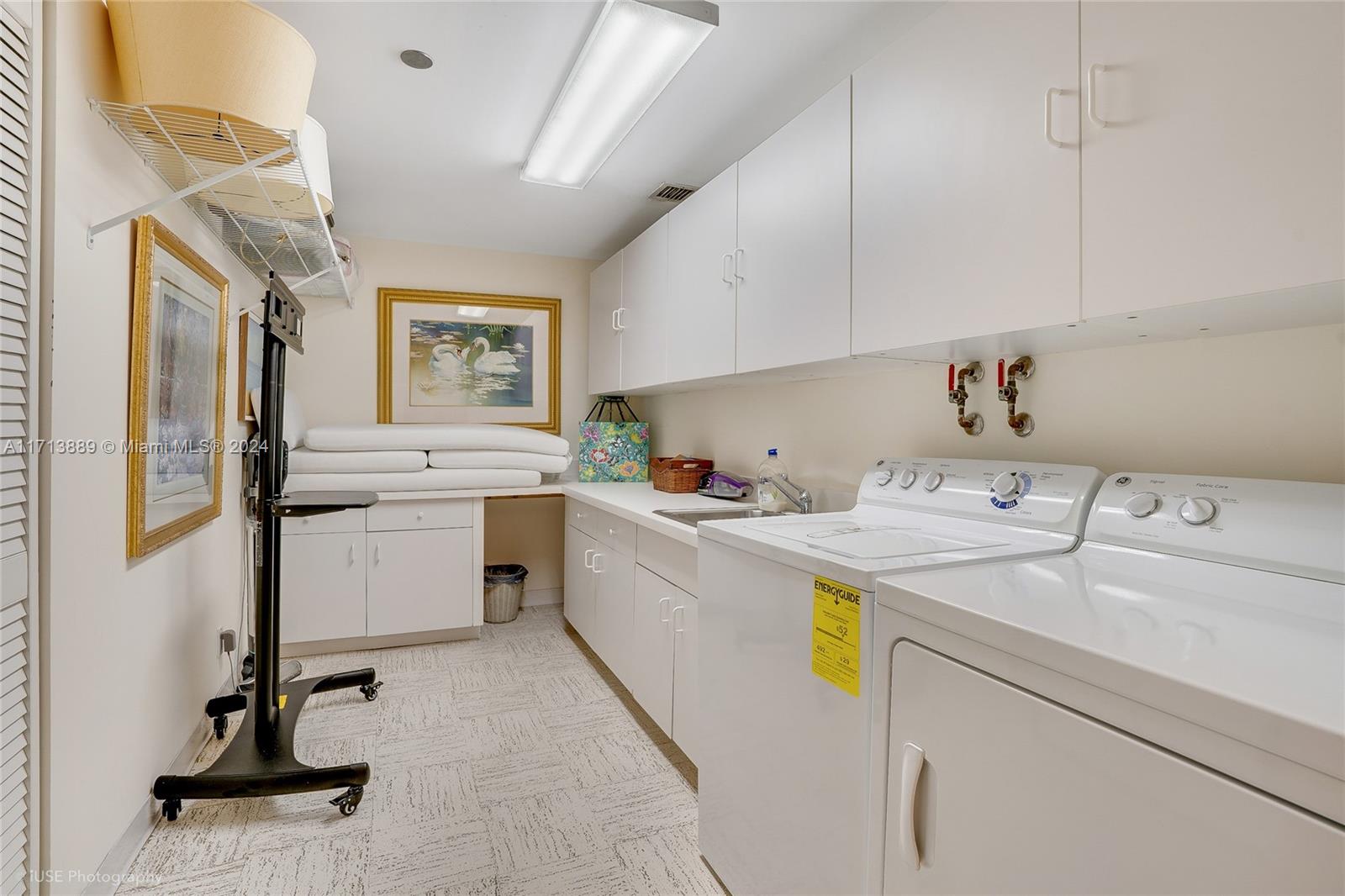 2100 South Ocean Boulevard, Unit 103N Palm Beach, FL 33480 - Photo 8 of 14 a kitchen with a sink a window and stainless steel appliances