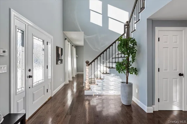 a view of entryway and hall with wooden floor