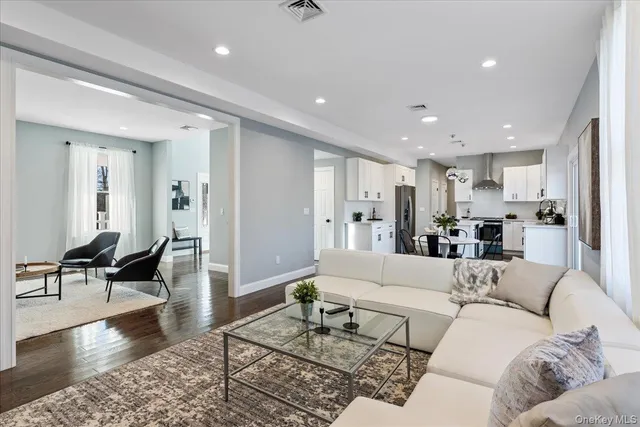 a living room with furniture and kitchen view