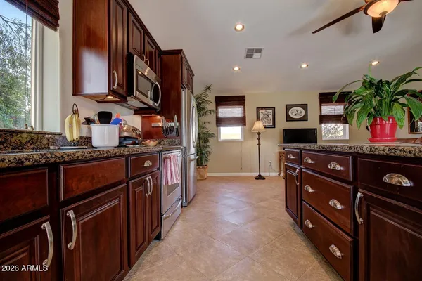 a kitchen with stainless steel appliances granite countertop a stove and cabinets