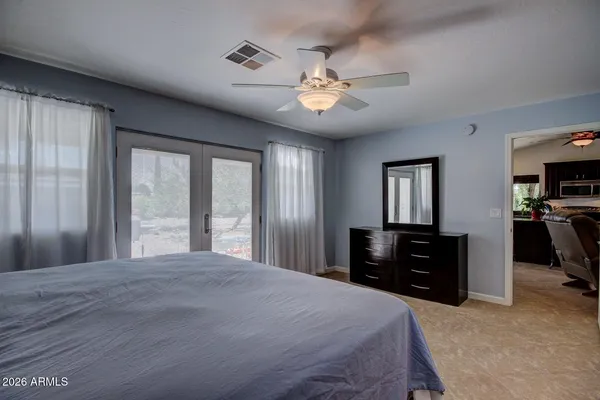 a bedroom with a large bed and a chandelier