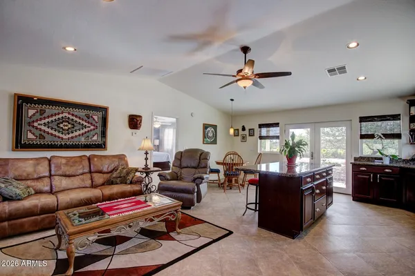 a living room with furniture ceiling fan and a rug
