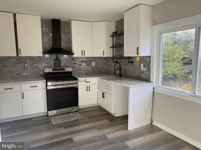 a kitchen with white cabinets appliances and a sink