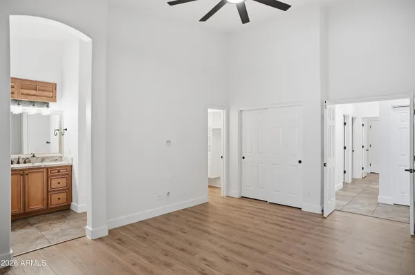 a view of a hallway with wooden floor and closet