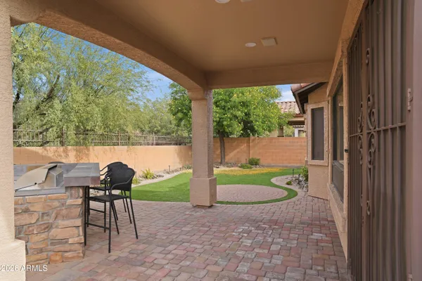 a view of a porch with furniture and garden