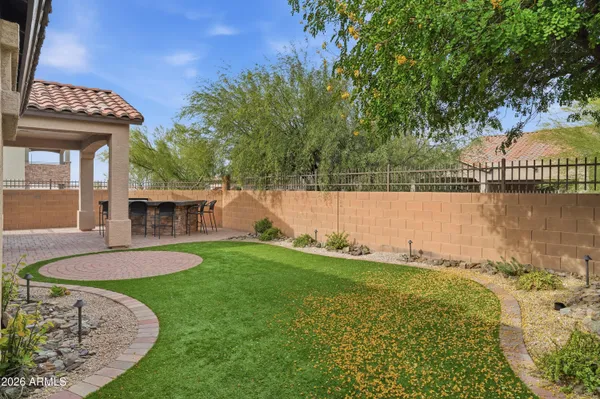 a view of a backyard with swimming pool and outdoor seating