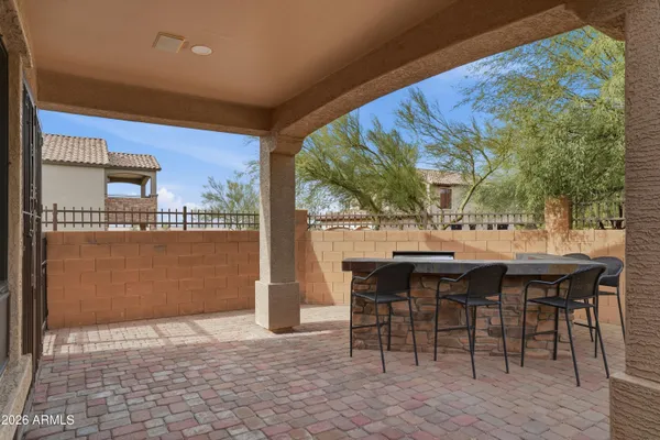 a view of a patio with table and chairs and potted plants