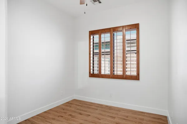 wooden floor in an empty room with a window