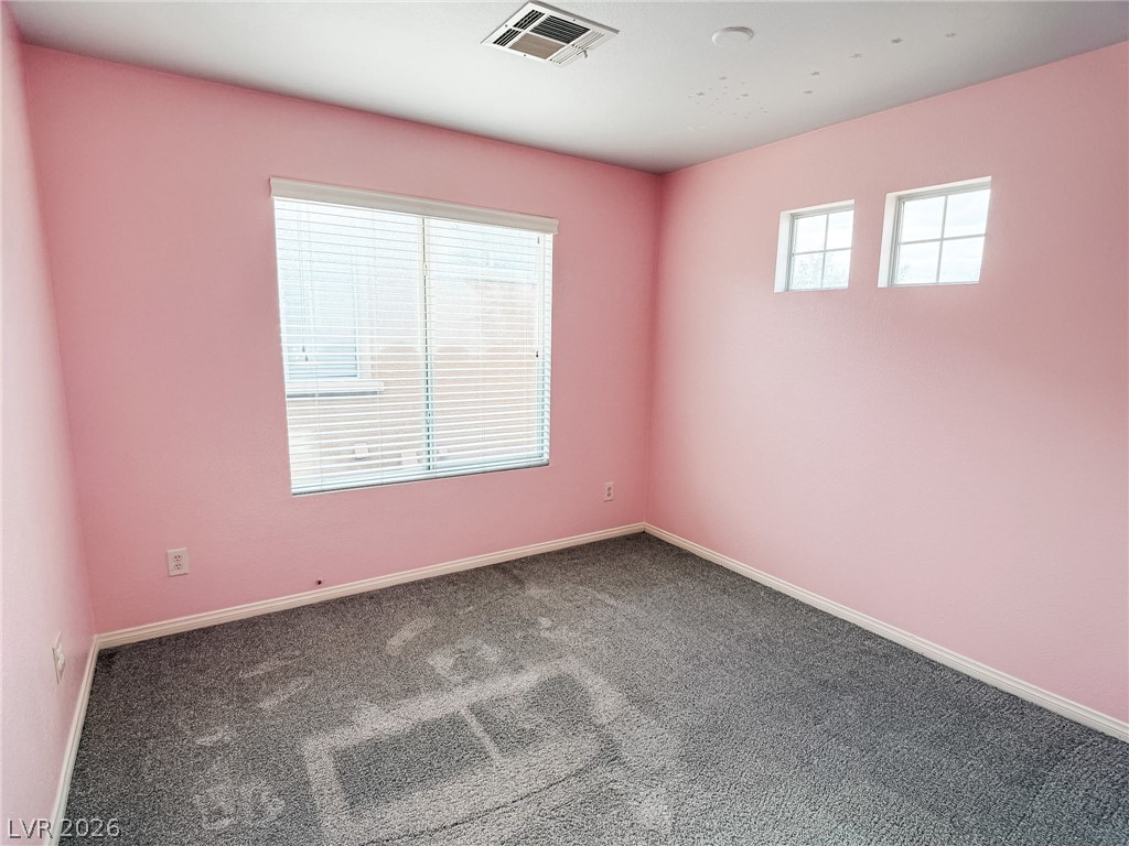 8683 Moreno Mountain Avenue Las Vegas, NV 89178 - Photo 14 of 26 Well-lit interior space with plush carpeting, offering a comfortable and versatile setting.