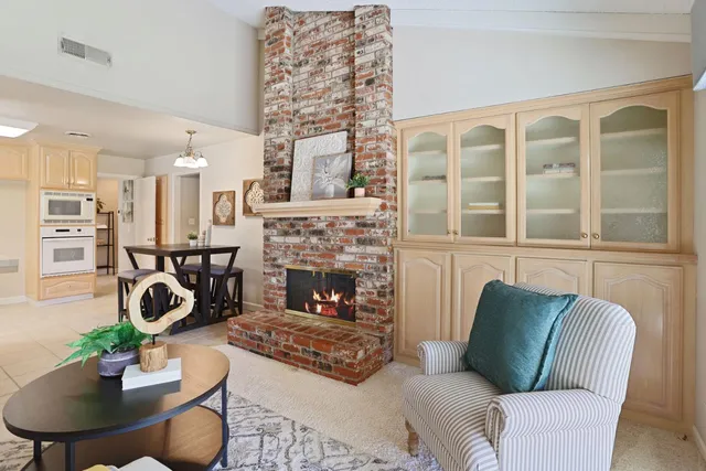 a living room with furniture a fireplace and a table