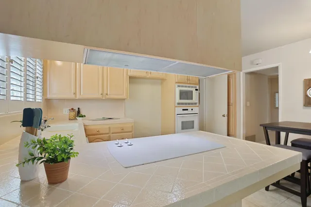 a bedroom with a bed and a potted plant