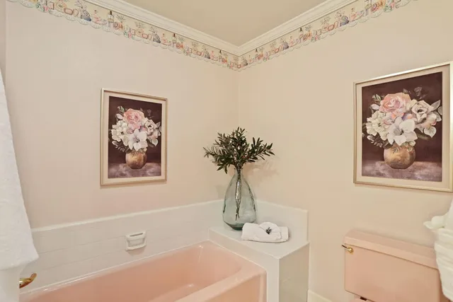 a bath room with a toilet a sink and a bath tub