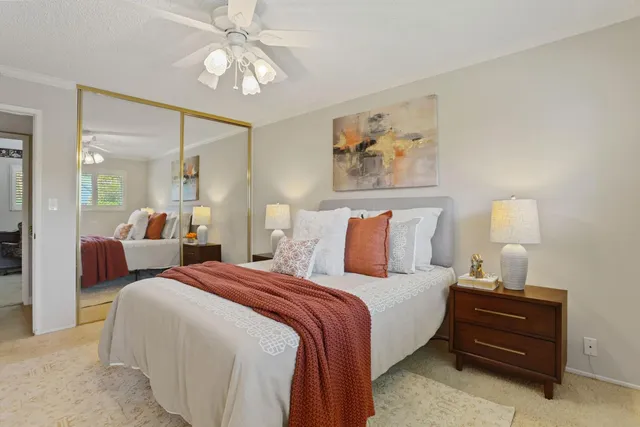 a bedroom with bed and a chandelier