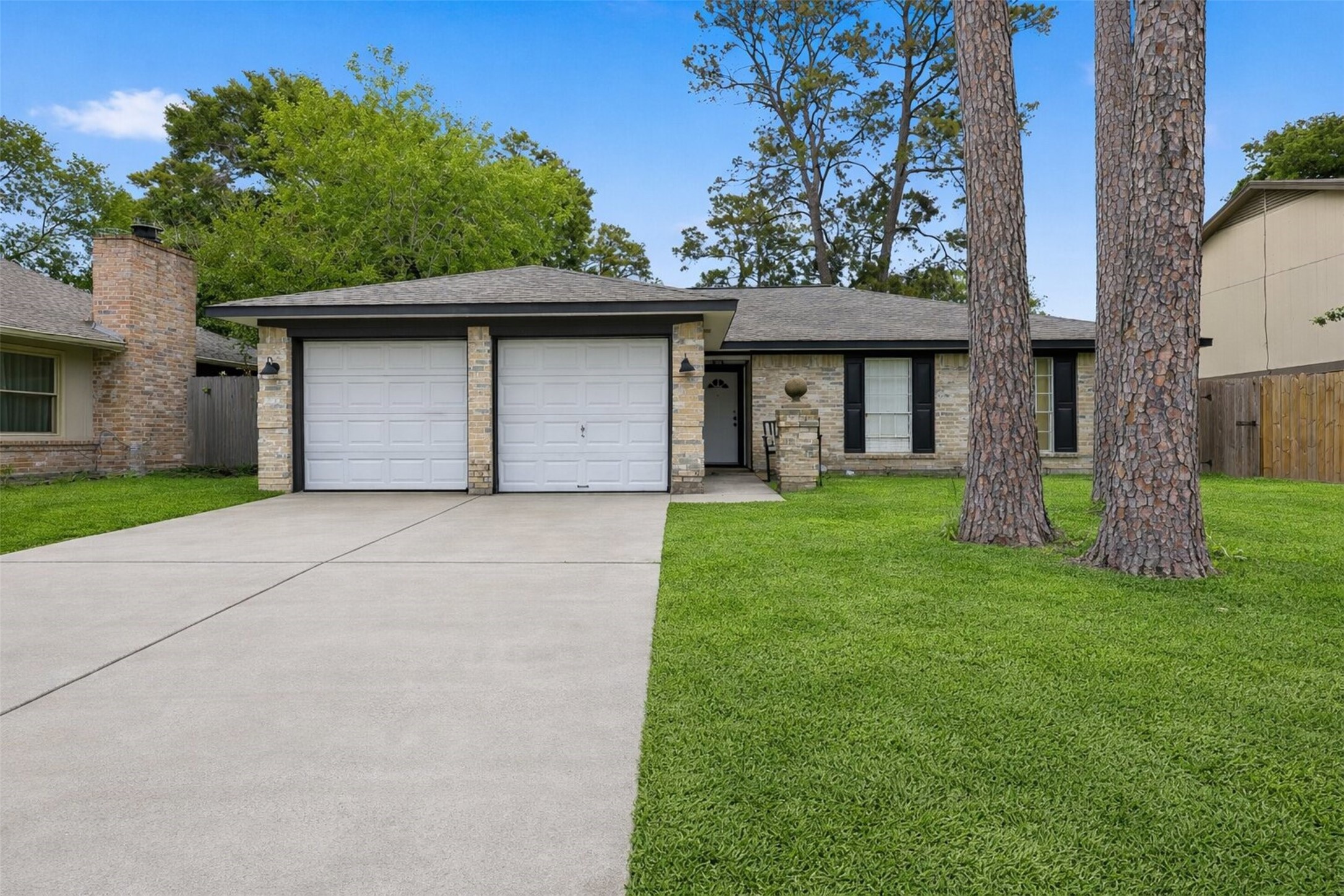 Double-wide driveway leads to a versatile residence