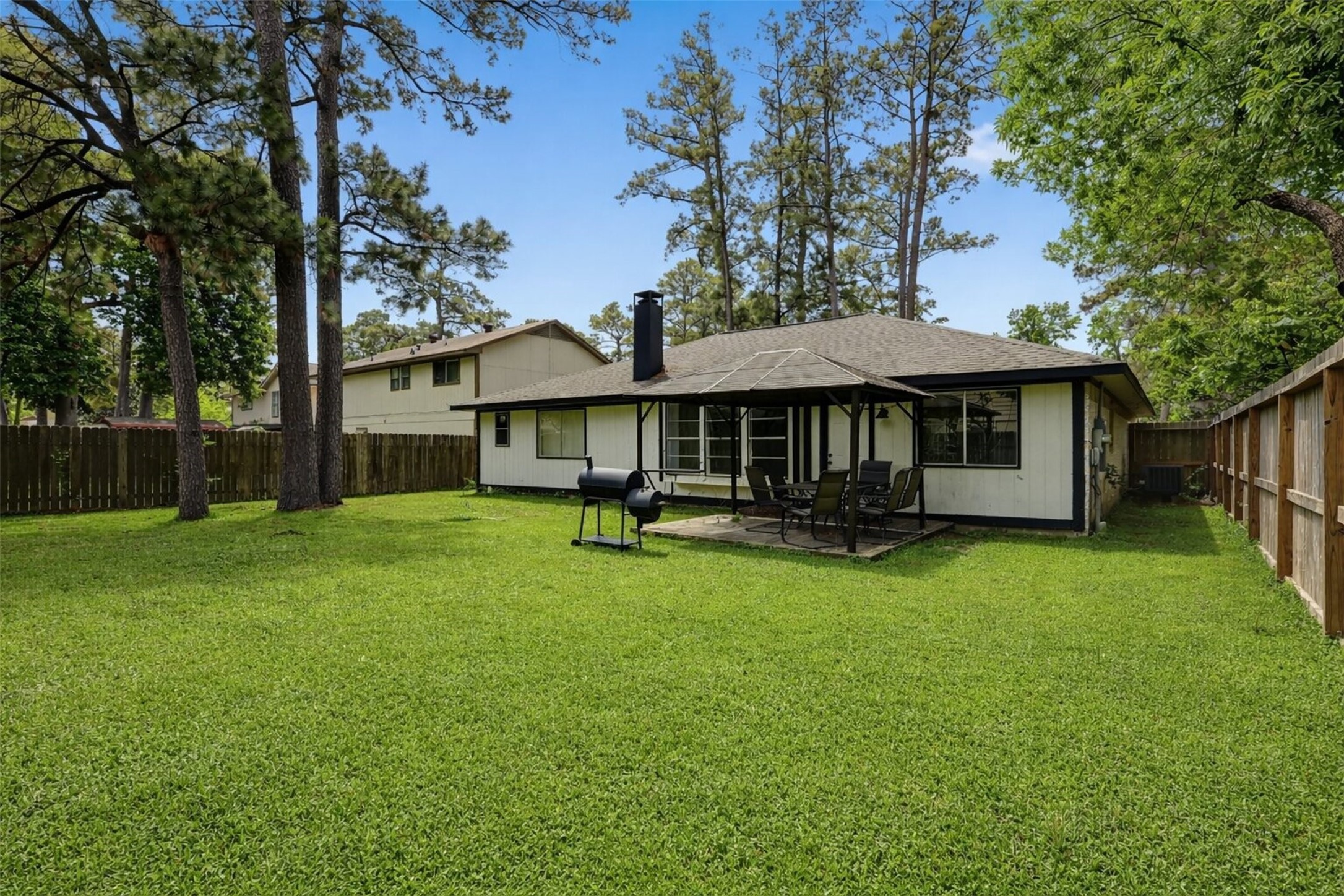 23310 Dew Wood Lane Spring, TX 77373 - Photo 5 of 24 Spacious backyard retreat featuring a custom pergola, perfect for outdoor dining and entertaining