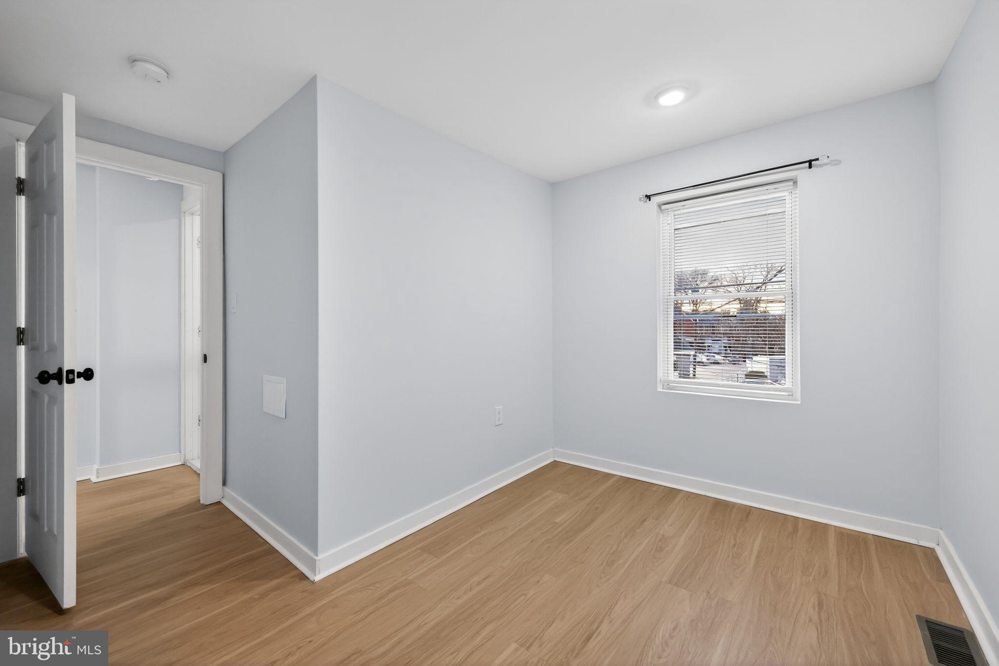 3055 Kearsarge Road Camden, NJ 08104 - Photo 13 of 26 a view of an empty room with wooden floor and a window