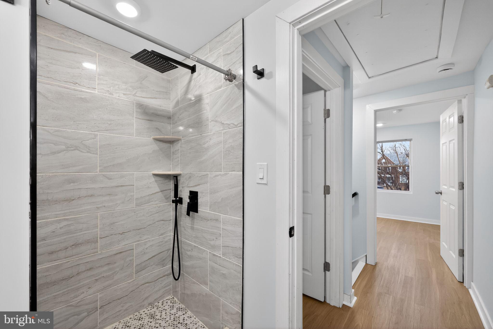 3055 Kearsarge Road Camden, NJ 08104 - Photo 17 of 26 a bathroom with a shower and a glass door
