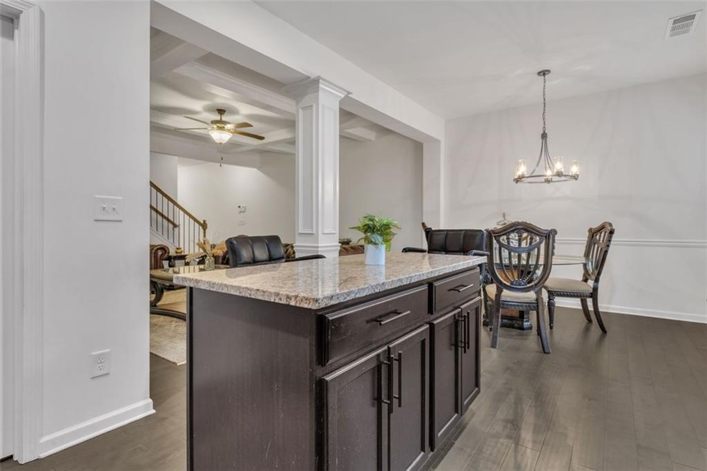 1563 Butternut Cove Stone Mountain, GA 30083 - Photo 12 of 35 a kitchen with kitchen island granite countertop a sink and a refrigerator