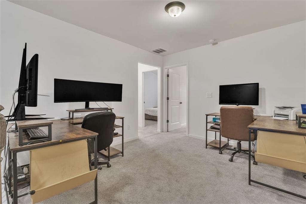 1563 Butternut Cove Stone Mountain, GA 30083 - Photo 16 of 35 a view of a livingroom with workspace and a flat screen tv