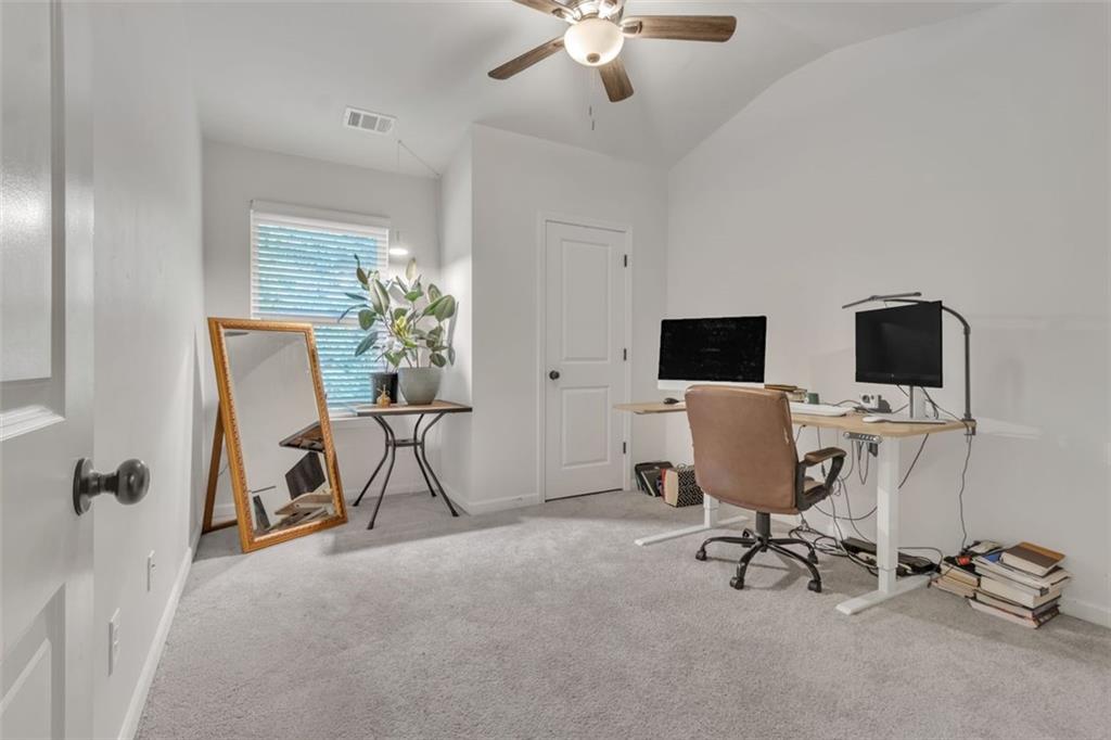1563 Butternut Cove Stone Mountain, GA 30083 - Photo 24 of 35 a view of a workspace with furniture and a ceiling fan