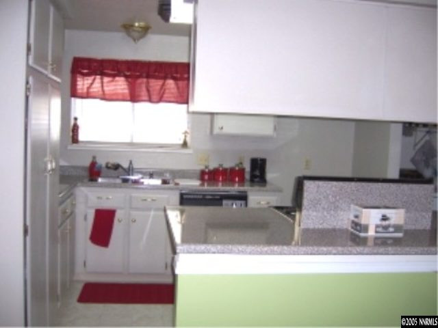 2811 Chavez Drive Reno, NV 89502 - Photo 5 of 6 a bathroom with a granite countertop sink and a mirror