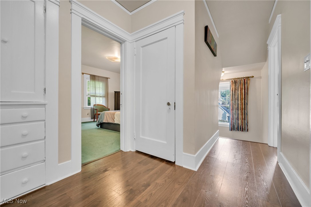 12699 Cedar Road Cleveland, OH 44106 - Photo 19 of 36 Hall with a healthy amount of sunlight and hardwoodflooring