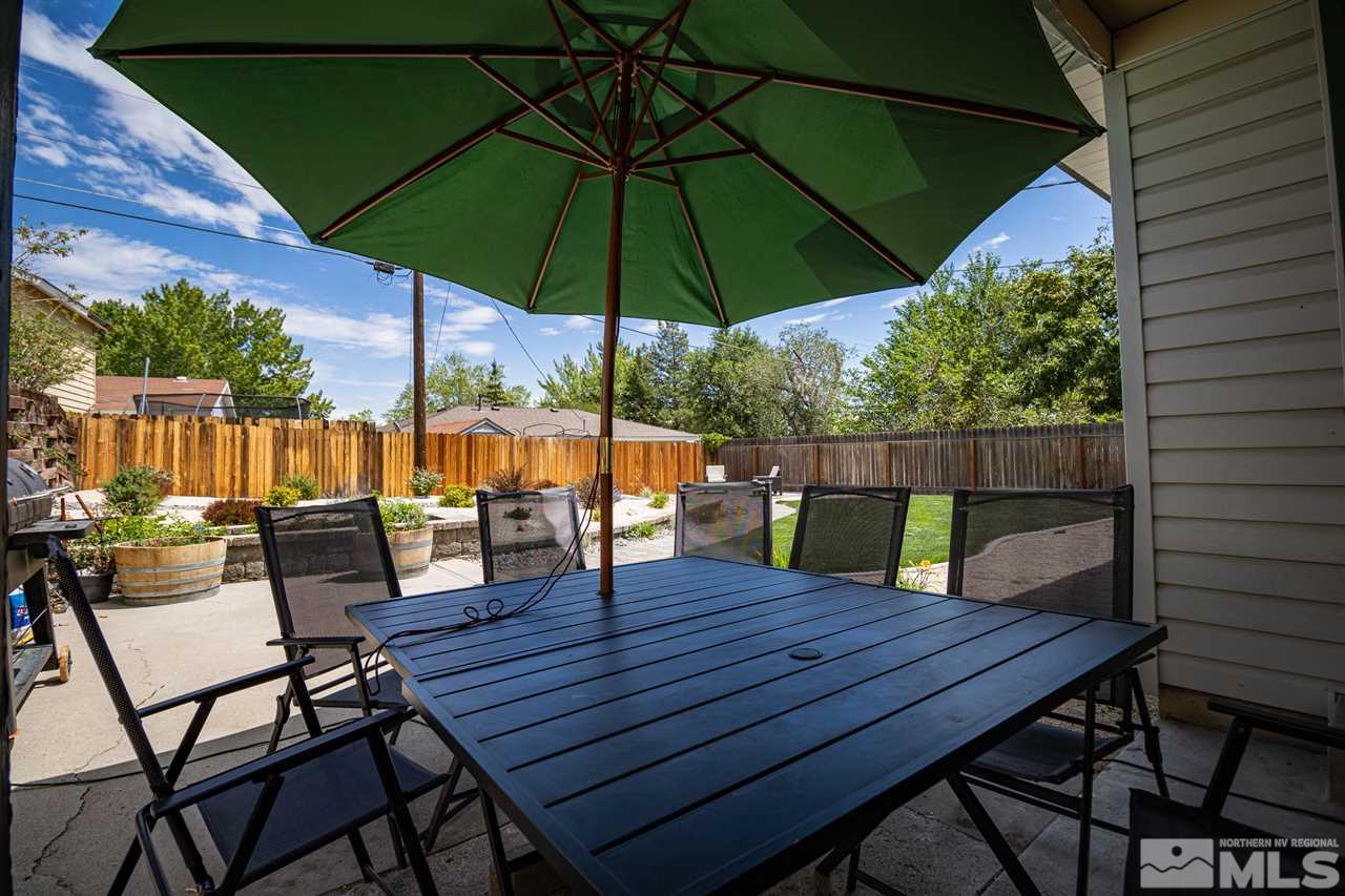 3520 Yosemite Place Reno, NV 89503 - Photo 4 of 16 a view of wooden table and chairs under an umbrella