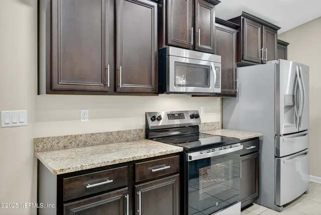 a kitchen with lots of counter top space sink and refrigerator