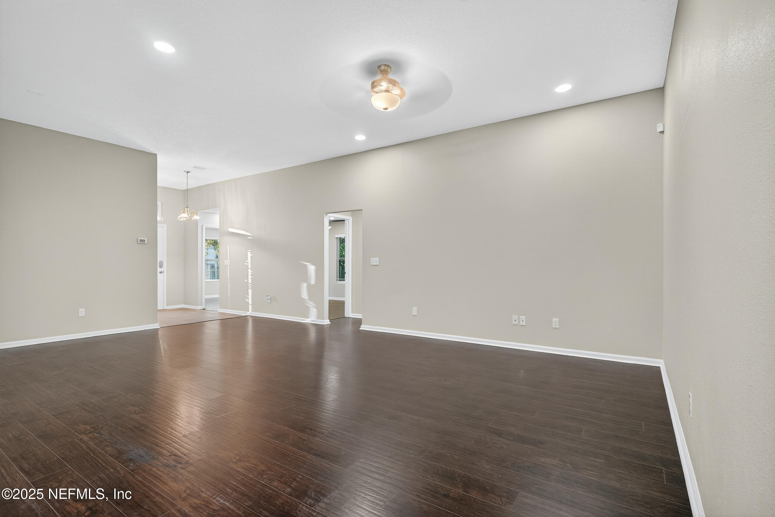 15885 Bainebridge Drive Jacksonville, FL 32218 - Photo 16 of 46 a view of an empty room with wooden floor