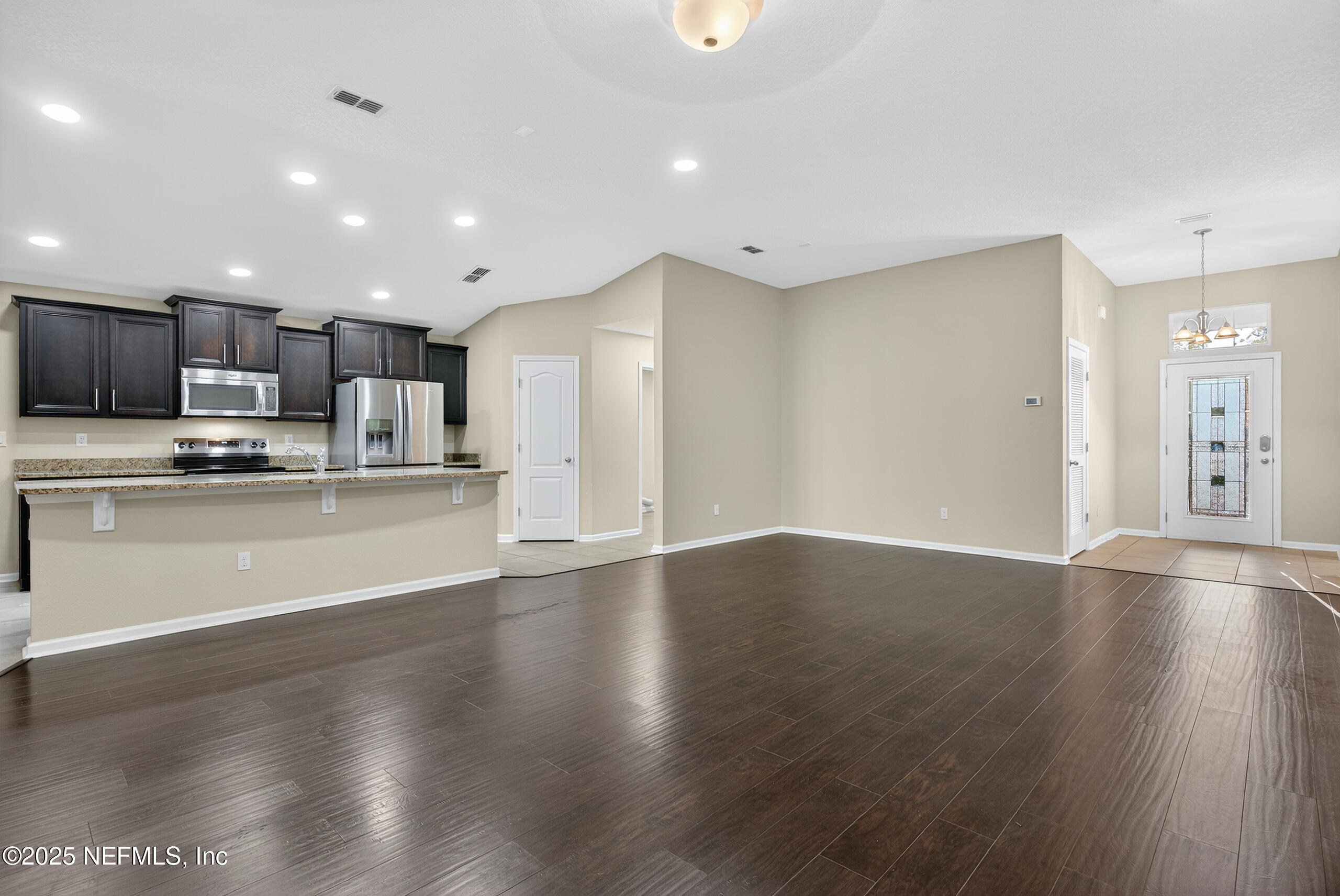15885 Bainebridge Drive Jacksonville, FL 32218 - Photo 17 of 46 a view of kitchen with wooden floor and window
