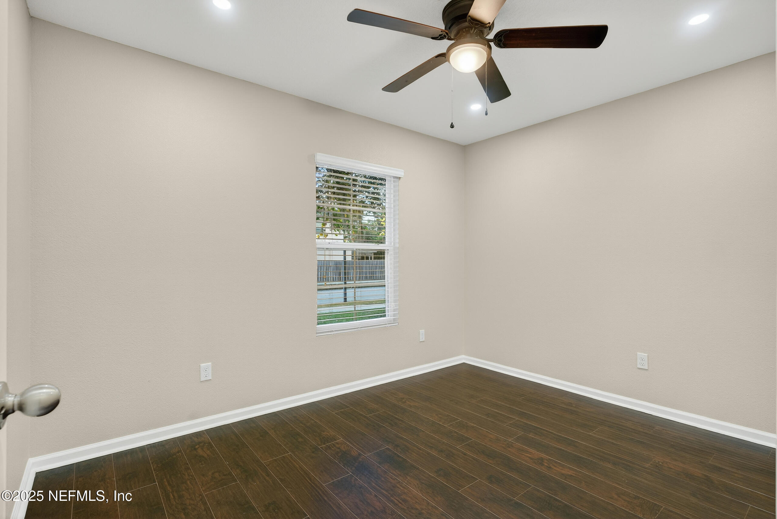 15885 Bainebridge Drive Jacksonville, FL 32218 - Photo 18 of 46 wooden floor in an empty room with a window