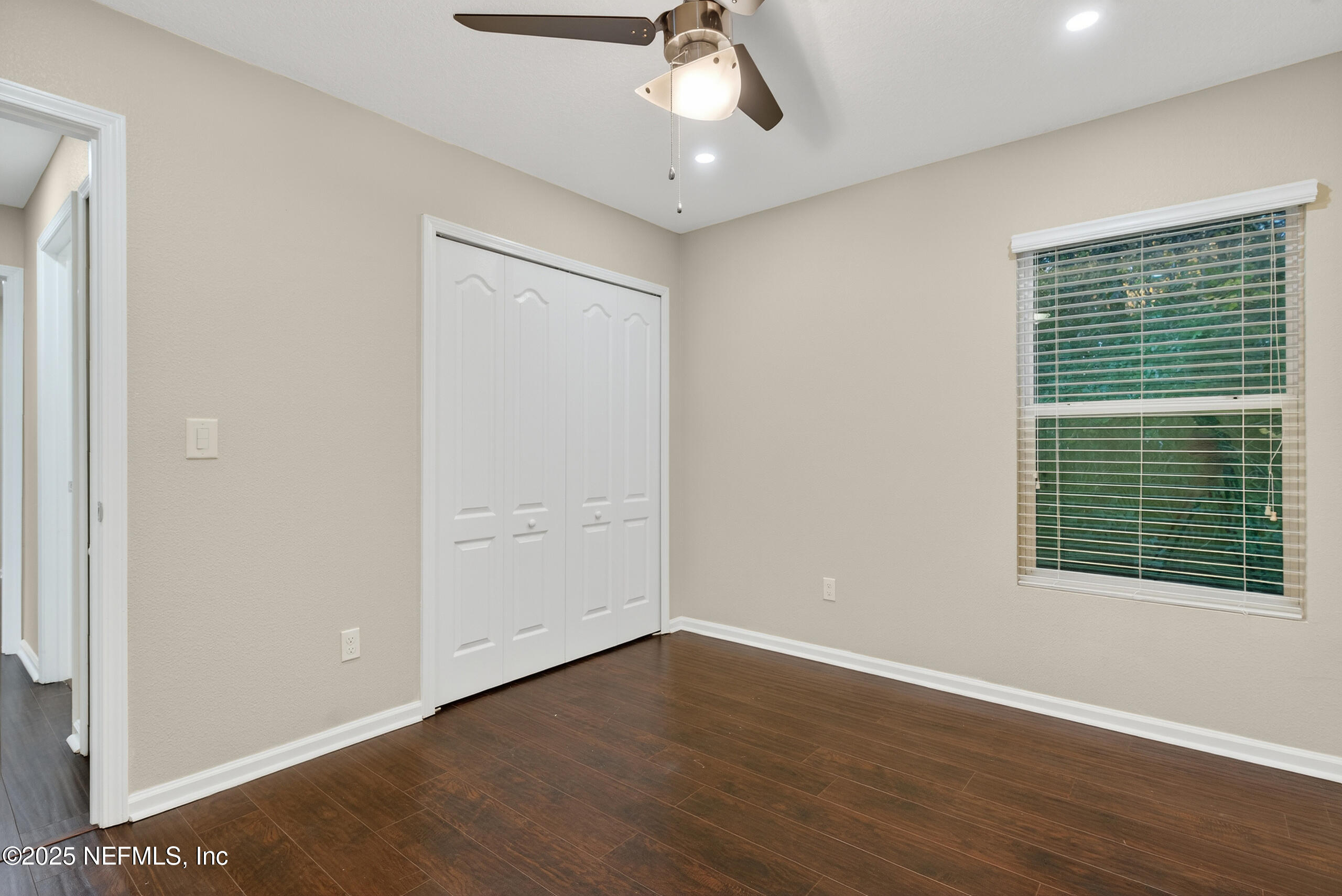 15885 Bainebridge Drive Jacksonville, FL 32218 - Photo 23 of 46 a view of an empty room with wooden floor and a window