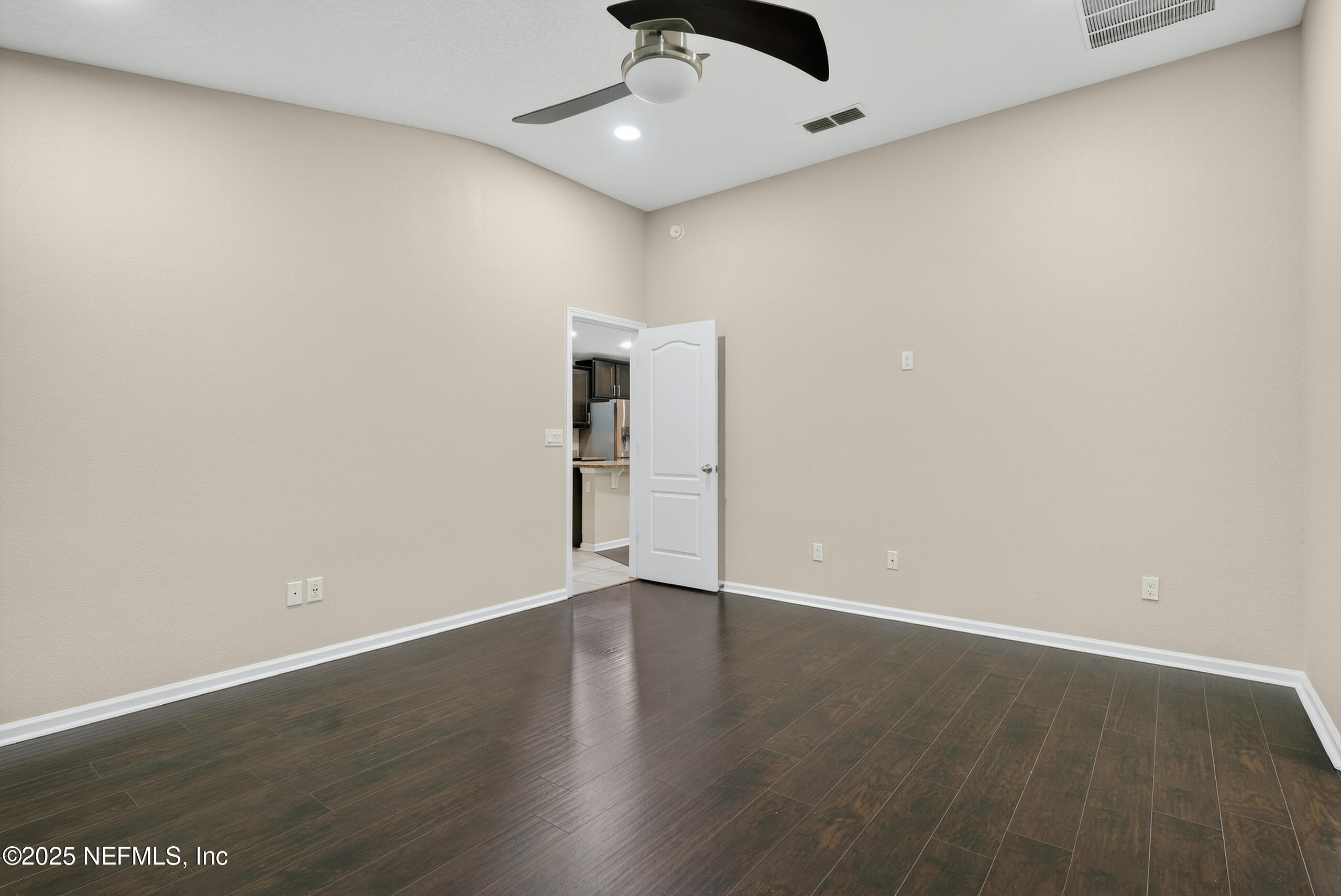 15885 Bainebridge Drive Jacksonville, FL 32218 - Photo 27 of 46 an empty room with wooden floor and ceiling fan